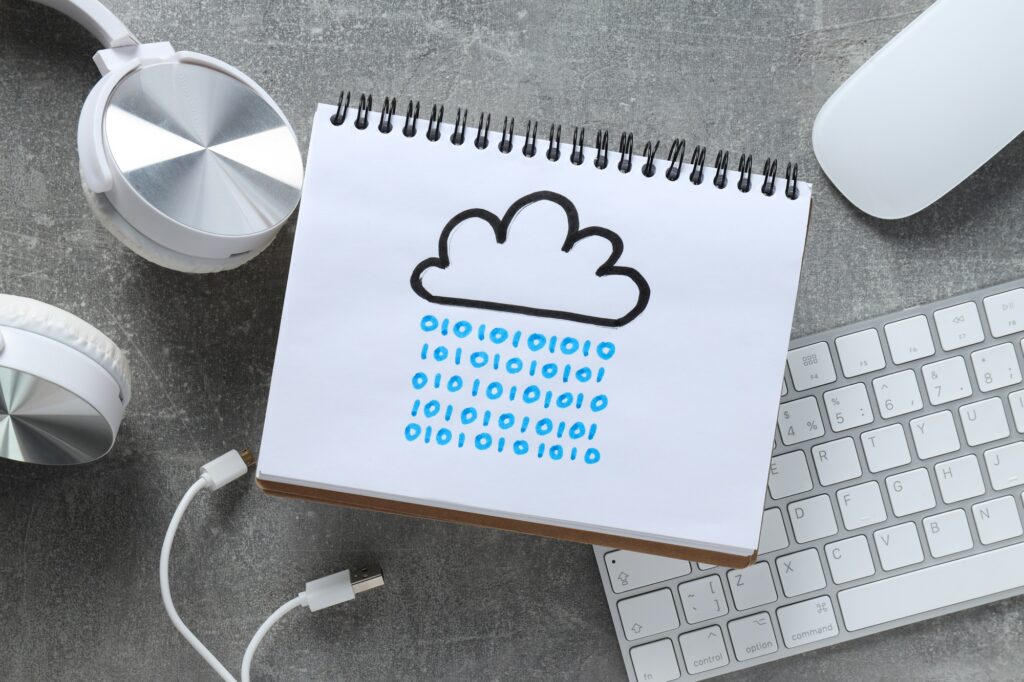 A notebook with a drawn cloud on a gray background