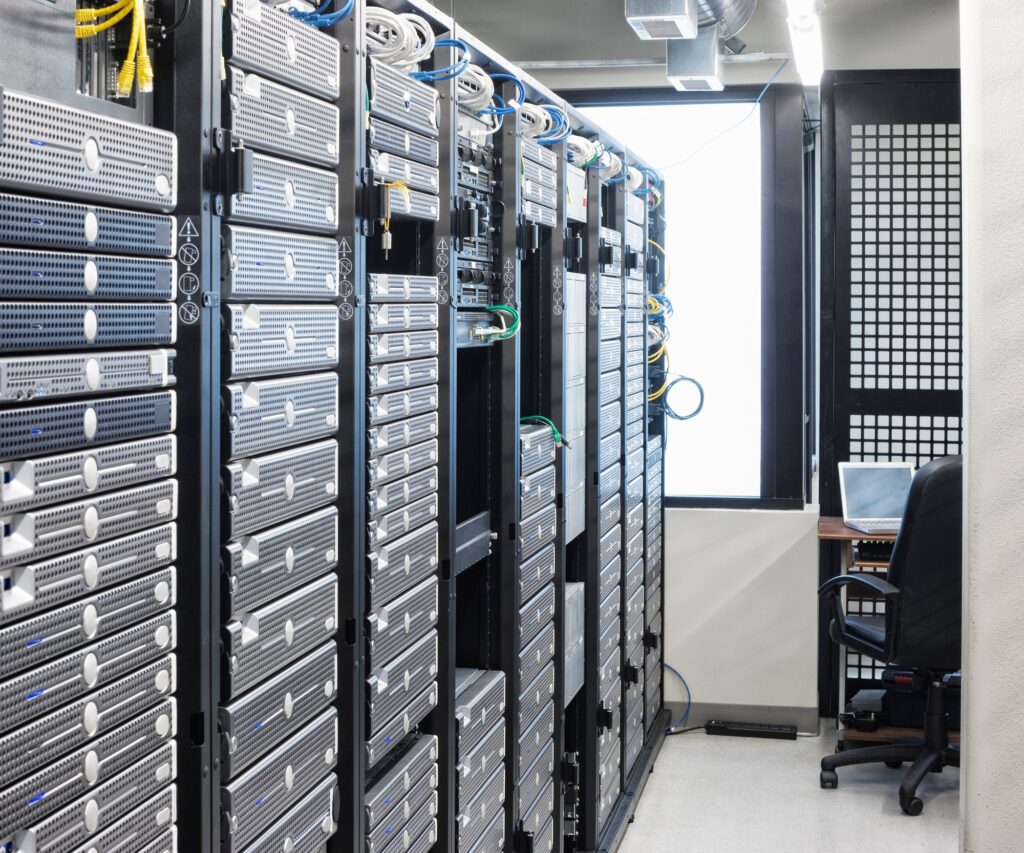 Servers in an aisle of racks in a computer server farm.